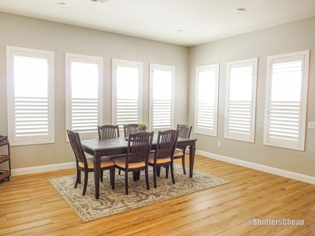 Living space featuring shutters with arched transoms